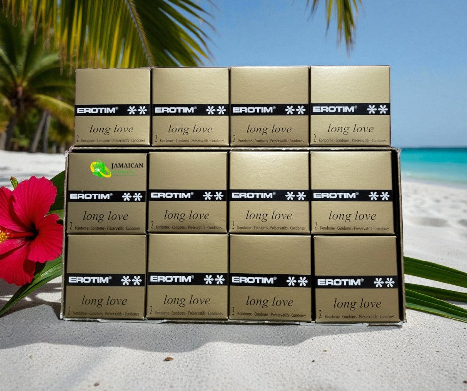 Erotim Long Love Delay Condoms 12 packs of 2’s stacked on tropical beach sand with a red hibiscus flower and ocean background, designed to prolong pleasure and help men last longer — available online in Canada.