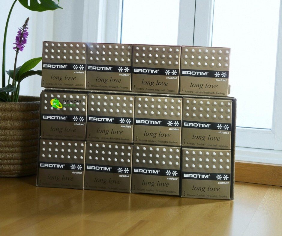 Erotim Long Love Studded Condoms 12 packs of 2’s stacked by a window, featuring a textured studded design that enhances pleasure and intimacy — available online in Canada.
