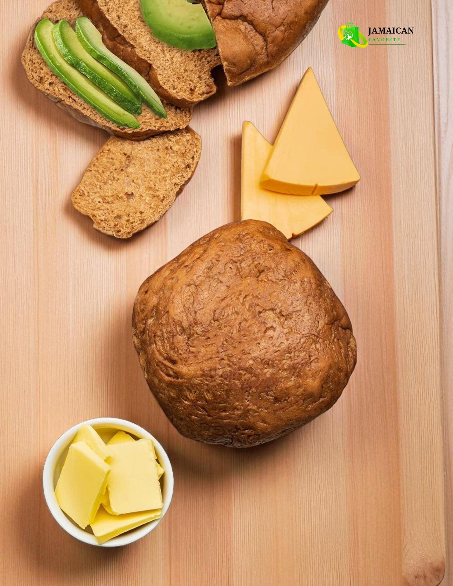 National Jamaican Spice Bun served with cheese, butter, and avocado slices on a wooden surface – authentic Caribbean snack loved across Canada.