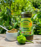 Walkerswood Traditional Jamaican Mix & Blenda Green Seasoning 10oz jar with fresh Scotch bonnet pepper and herb paste on wooden table – authentic Caribbean flavor available online in Canada.